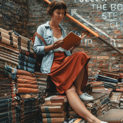 Reading on Pile of Books